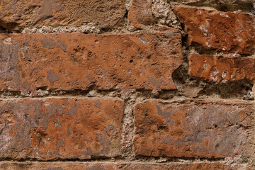 Close up red brick wall, old and cracked stone  wall, with space for texture background, no person
