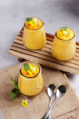 Mango sago. Sweet sago cream with mango, coconut milk and mango juice garnish with edible flower.