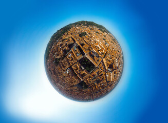 Aerial little planet view of Bologna, Italy at sunset. Colorful sky over the historical city center with car traffic and old buildings roofs. Travel and vacation concept. Italy, Europe