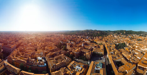 Aerial view of Bologna, Italy at sunset. Colorful sky over the historical city center with car traffic and old buildings roofs. Travel and vacation concept. Italy, Europe
