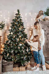 Family decorating beautiful Christmas tree in room