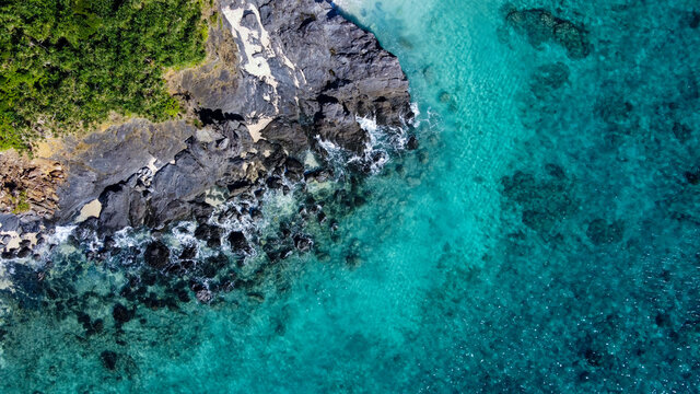 岩場にぶつかる白波を真俯瞰で撮影したドローン写真 © NinjaTech LLC