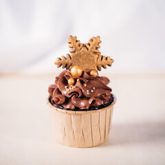 Chocolate cupcakes with star shaped cookies on a wooden background. Christmas mood. Sweets for any occasion