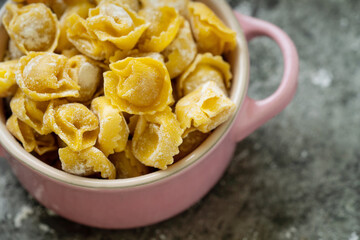 Raw Uncooked Cappelletti with flour