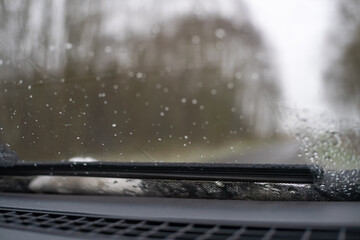 Close-up of the windshield wiper with wet snow, photo from inside