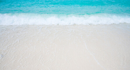 Fototapeta na wymiar Beach with white sand and soft blue ocean wave