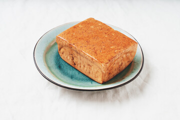 Brick of organic somoked tofu cheese