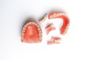 Dental prosthetics on a white background. Dentures. Prosthetic teeth. False teeth. Prosthetic dentistry. Set of dentures on a white background. Top view of complete denture on white background