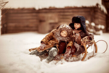 children in winter, snowdrifts, sledges, lots of snow, frost, winter warm clothes, village