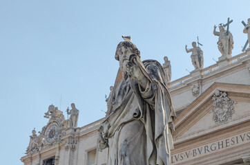 Fototapeta na wymiar Statue of St. Paul outside the basilica of Saint Peter the Basilica facade Vatican City, Rome, Italy