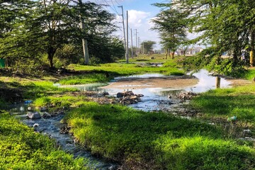 Filty water flowing next to a highway in Nairobi, Kenya