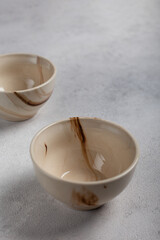 Two white clay bowls on a light background