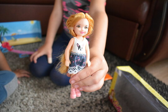 a small child plays with a doll