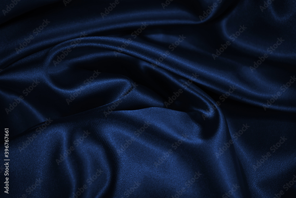 Wall mural dark blue elegant background. crumpled satin texture background. the surface of a dark blue shiny fa