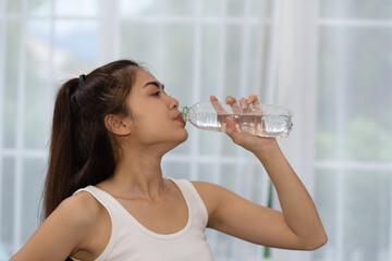 Fitness Asian woman drinking water after exercising, health and sport