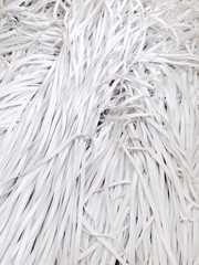Lots of white elastic bands for clothes, face masks, underwear. Background on the theme of light industry