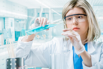 Female reasearcher conducting an experiment in a lab