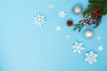 Fototapeta premium Christmas holiday and happy new year winter composition and snowflakes decoration on blue background, flat lay, top view and copy space, for banner card