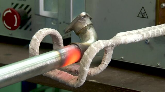 High-frequency induction brazing of fittings for connecting engine. Close-up. Repair technological process. Aviation. Gas turbine engine repair.