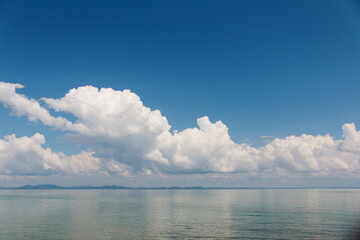 Naklejka na ściany i meble Bright sky with white clouds above the sea, for background.