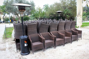 Chairs, tables and other furniture stacked outside closed cafe-restaurant due to Covid-19 lockdown - Athens, Greece, November 3 2020.