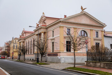 Historical neo classical building with columns and griffins on the roof, Sokolovna, gymnastics organization Sokol movement, autumn day, Cesky Brod, Central Bohemia, Czech Republic