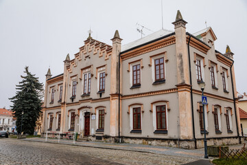 Fototapeta na wymiar Historical neo renaissance primary school building at main town Husovo Square at cloudy autumn day, Cesky Brod, Central Bohemia, Czech Republic
