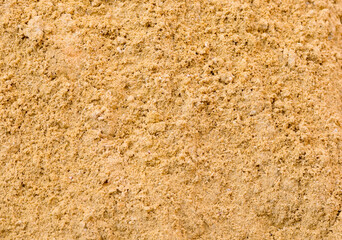 River sand, flat surface of yellow quartz wet sand in a quarry.