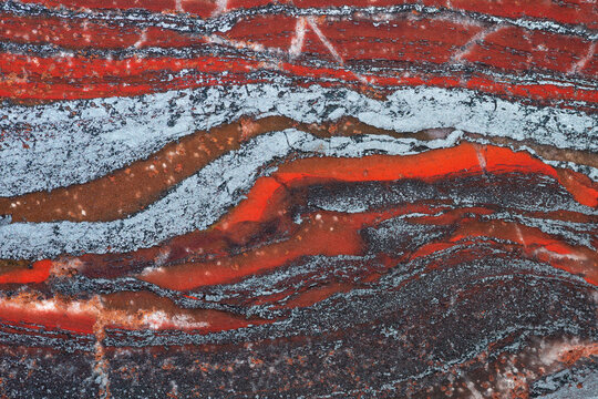 Full-screen texture of red ferruginous quartzite (jaspillite) rock. Natural stone background.