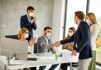 Group of business people have a meeting and working in office and wear masks as protection from coronavirus