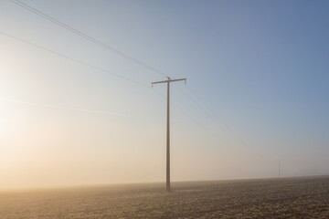 Fototapeta na wymiar power lines in fog