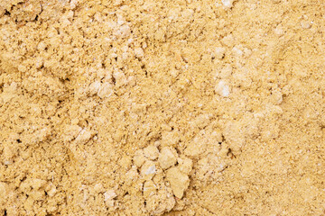River sand, flat surface of yellow quartz wet sand in a quarry.