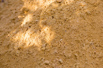 River sand, flat surface of yellow quartz wet sand in a quarry.