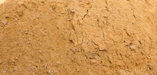 River sand, flat surface of yellow quartz wet sand in a quarry.