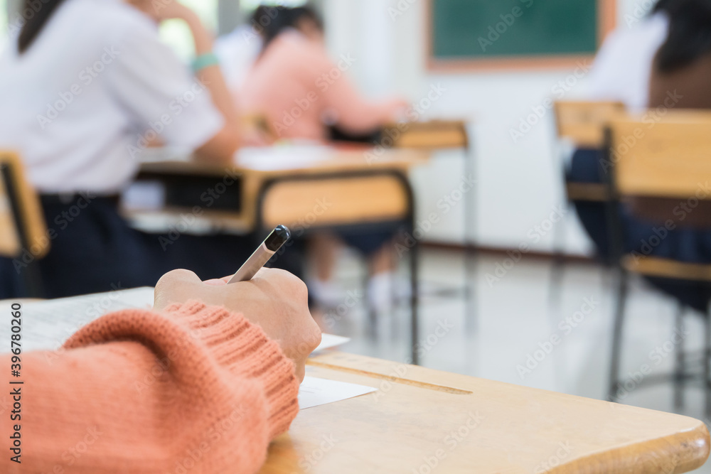 Wall mural hand student taking exam or test in exercise taking fill in exam carbon paper computer sheet with pe