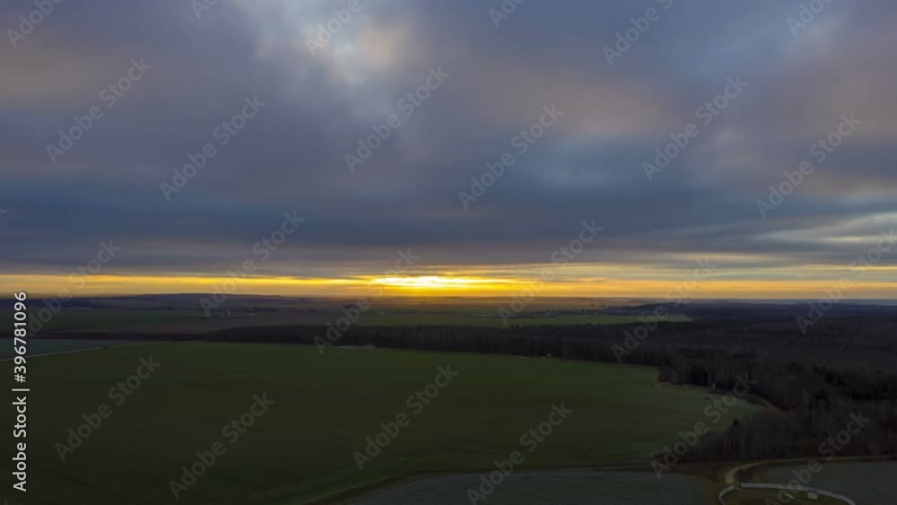 Poster Beautiful rural landscape bird's-eye view at sunrise, hyperlapse. Aerial view of agricultural landscape with fields in autumn season. 
