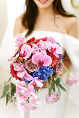 A flower bouquet held by a bride on her wedding