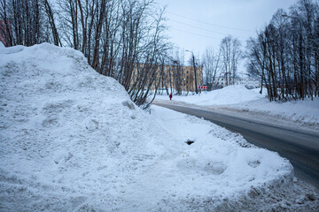Winter street. Huge amount of snow, large snowdrifts, snowy time