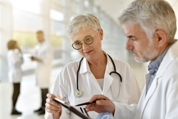 Mature doctors meeting before surgery