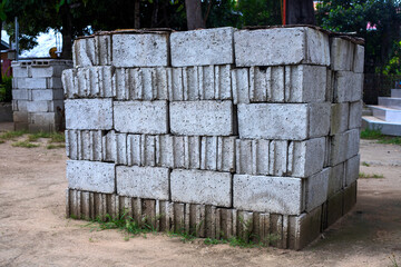 White concrete bricks in pile at construction site. Road or building construction process. Solid concrete material. Urban landscape