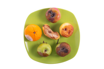spoiled fruit set on a plate, isolate on a white background