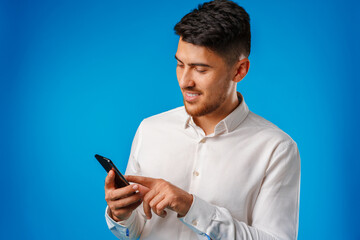 Young man in white shirt using his smartphone