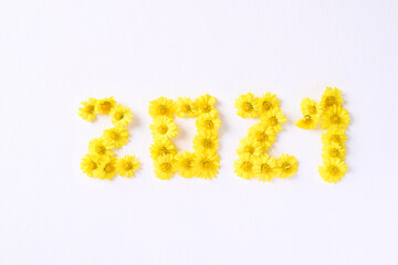 2021 new year made from yellow Chrysanthemum flower petal on white background