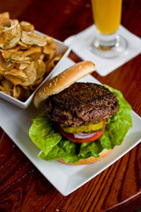 Hamburger. Grade A grass fed angus beef, ground into hamburger meat. Hamburger patties seasoned w/ salt & pepper & flame grilled topped w/ cheddar cheese. O toasted bun w/ lettuce tomato onion Cheese