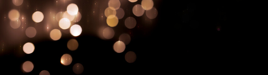 Beautiful festive bokeh on a black background golden circles, light night bokeh effect, deflated....