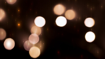 Beautiful festive bokeh on a black background golden circles, light night bokeh effect, deflated. Festive postcard, night view.