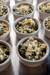 Spinach artichoke dip. Classic holiday party dip favorite. Spinach, artichokes, onions, garlic sautéed in butter, baked, topped with Parmesan cheese, crackers and served with toasted bread.