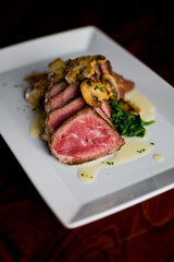 Steak and potatoes. Grade A grass fed angus beef steaks. Tenderloin, filet mignon, New York strip, bone in rib-eye grilled medium rare on outdoor wood-fired grill. Classic American steakhouse entree.
