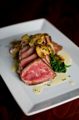 Steak and potatoes. Grade A grass fed angus beef steaks. Tenderloin, filet mignon, New York strip, bone in rib-eye grilled medium rare on outdoor wood-fired grill. Classic American steakhouse entree.
