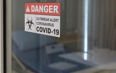 Outbreak alert signage in front of control area, quarantine room. Outbreak alert and coronavirus covid 19 sign. Quarantine room with Coronavirus alert sign. Covid-19 and disinfection concept.